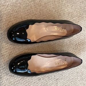 Black patent luxury brand shoes.